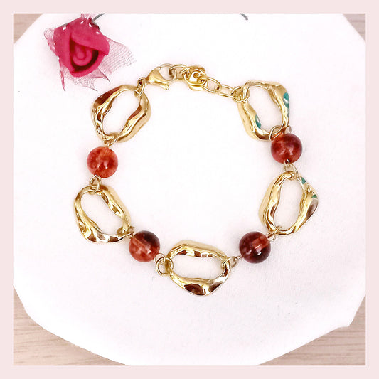 pulsera ancha de círculos y bolas marrones de acero